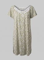 A short-sleeve nightgown with a white floral pattern on an olive green base, featuring a scalloped lace-trimmed neckline, shown against a solid gray background.
