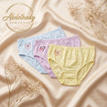 Three pairs of women's briefs in pastel blue, lavender, and pale yellow, arranged on a champagne satin background with dried floral props. The brand name Abdelhady Homewear is displayed in the upper left.