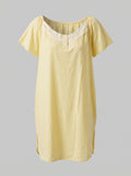 A pale yellow short-sleeve nightgown with a scoop neckline and white lace trim, displayed against a solid gray background.